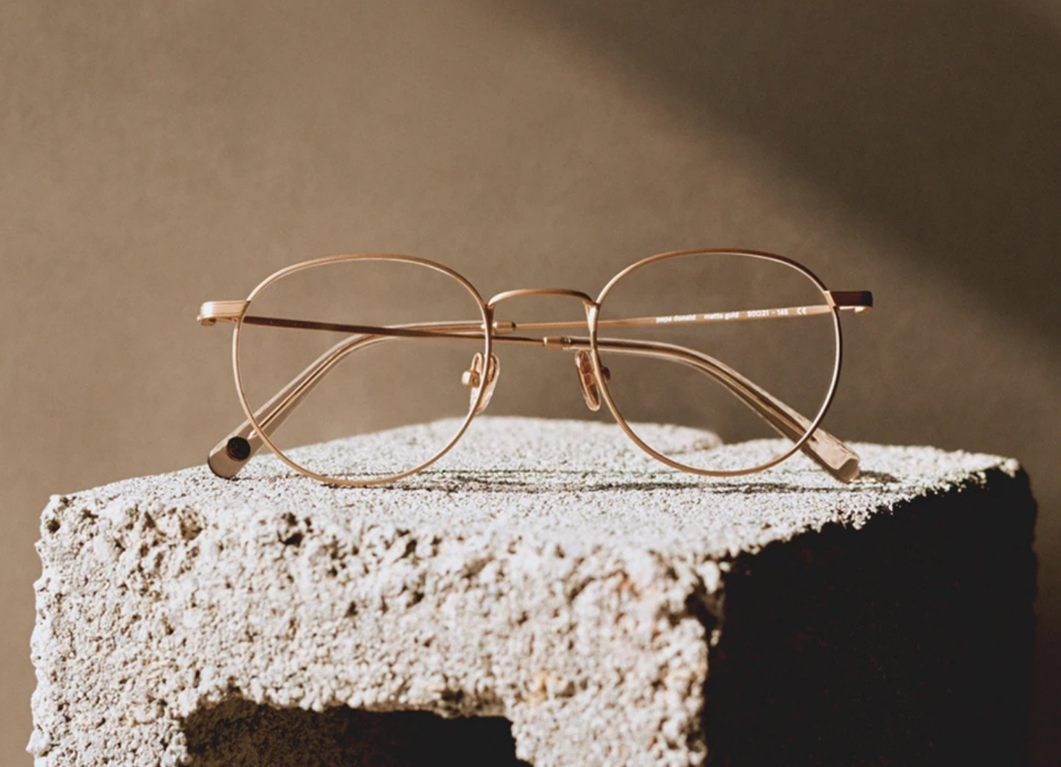 a pair of golden framed glasses